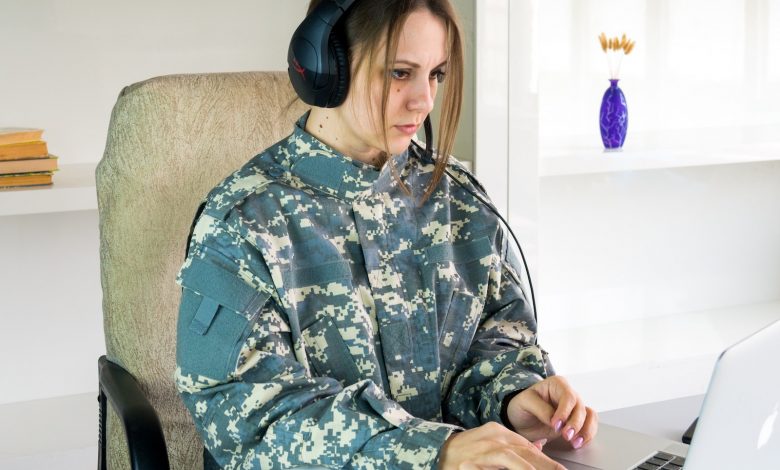 a woman wearing headphones sitting in front of a laptop computer